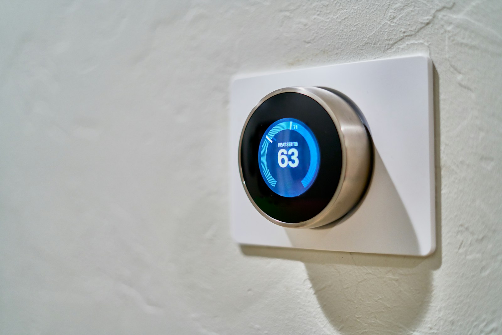 Smart thermostat on a wall set for heating
