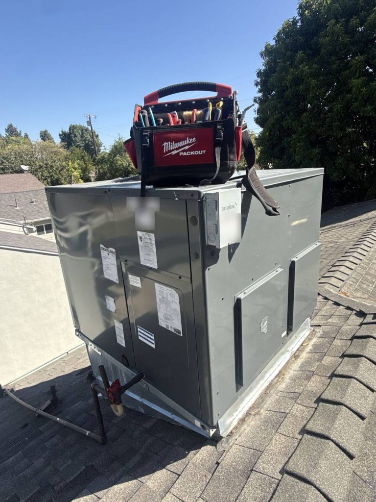 HVAC technician’s tool bag on top of a rooftop package unit during a service call